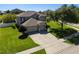 Two-story home with a well-maintained lawn, mature trees, and a spacious driveway at 2821 Columbus Ave, Clermont, FL 34715