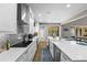 Bright kitchen with white cabinets, tile backsplash, quartz countertops, stainless steel appliances and open layout at 2821 Columbus Ave, Clermont, FL 34715
