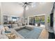 Bright living room with vaulted ceilings, fan, large sectional, tile floors and sliding doors to the pool at 2821 Columbus Ave, Clermont, FL 34715