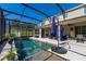 Inviting in-ground pool with a screened enclosure, complemented by comfortable seating and landscaping at 2821 Columbus Ave, Clermont, FL 34715