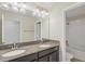 Bathroom featuring double vanity with granite counters and shower-tub combo at 2901 Harvest Hill Ln, Orlando, FL 32824