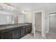 Bathroom boasting double sinks, granite countertop, dark cabinets, and a separate area for toilet and shower at 2901 Harvest Hill Ln, Orlando, FL 32824