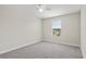 Bedroom featuring neutral carpet, a ceiling fan, and large window at 2901 Harvest Hill Ln, Orlando, FL 32824