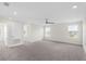 Expansive bedroom with neutral carpet, ceiling fan, and several windows providing natural light and ventilation at 2901 Harvest Hill Ln, Orlando, FL 32824