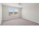 Bedroom featuring neutral carpet, ceiling fan, and sunny double windows at 2901 Harvest Hill Ln, Orlando, FL 32824