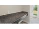 Desk area with granite countertop, positioned near a door and window to let the light shine through at 2901 Harvest Hill Ln, Orlando, FL 32824