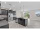Spacious kitchen with island featuring dark wood cabinets, granite countertops and stainless appliances at 2901 Harvest Hill Ln, Orlando, FL 32824