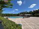 Large community pool with patio area and tables at 2901 Harvest Hill Ln, Orlando, FL 32824
