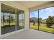 View of the screened patio with large sliding glass doors and neighborhood views at 2901 Harvest Hill Ln, Orlando, FL 32824