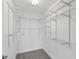 Walk-in closet featuring adjustable wire shelving and neutral carpet at 2901 Harvest Hill Ln, Orlando, FL 32824
