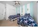 Bright bedroom with two twin beds, nautical decorations and a closet with sliding doors at 2902 Paddington Way, Kissimmee, FL 34747