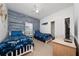 Nautical themed bedroom with two beds, gray wood accent wall, and a closet at 2902 Paddington Way, Kissimmee, FL 34747