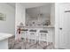 Breakfast bar featuring three white high-top chairs at 2902 Paddington Way, Kissimmee, FL 34747