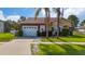 Charming single-story home with a stone facade, two-car garage, and well-maintained landscaping at 2902 Paddington Way, Kissimmee, FL 34747