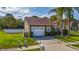 Charming single-story home with a two-car garage, and well-maintained landscaping at 2902 Paddington Way, Kissimmee, FL 34747