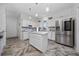 Modern kitchen with stainless steel appliances, white cabinets, and a center island at 2902 Paddington Way, Kissimmee, FL 34747