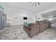 Well-lit living room featuring vaulted ceilings, modern flooring, and seamless flow to kitchen at 2902 Paddington Way, Kissimmee, FL 34747