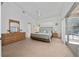 Spacious main bedroom featuring a king size bed, vaulted ceiling, and sliding glass doors to the pool at 2902 Paddington Way, Kissimmee, FL 34747