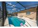 Backyard pool area featuring ample seating and a privacy screen, perfect for outdoor enjoyment at 2902 Paddington Way, Kissimmee, FL 34747