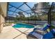 Enclosed pool area with lounge chairs, providing a relaxing backyard oasis with a privacy fence at 2902 Paddington Way, Kissimmee, FL 34747