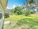 Large backyard with a lush lawn, partial fencing, and mature landscaping at 3110 Short Leaf Pine Ct, Kissimmee, FL 34746