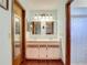 Well-lit bathroom features double sinks, mirrors, and a shower, offering functionality and comfort at 3110 Short Leaf Pine Ct, Kissimmee, FL 34746