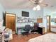 Functional bedroom with a ceiling fan, desk, and access to an ensuite bathroom at 3110 Short Leaf Pine Ct, Kissimmee, FL 34746