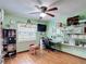 A versatile bedroom space featuring a ceiling fan, desk area, and ample shelving for storage at 3110 Short Leaf Pine Ct, Kissimmee, FL 34746