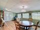 Bright dining room has laminate flooring, drop ceiling, and plenty of natural light at 3110 Short Leaf Pine Ct, Kissimmee, FL 34746