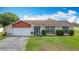 Charming single-story home with a well-maintained lawn and attached two-car garage at 3110 Short Leaf Pine Ct, Kissimmee, FL 34746