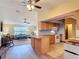 Open kitchen featuring wood cabinets, neutral countertops, and a breakfast bar at 3110 Short Leaf Pine Ct, Kissimmee, FL 34746