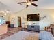 Open living room featuring vaulted ceiling, ceiling fan, wood-look floors and neutral paint at 3110 Short Leaf Pine Ct, Kissimmee, FL 34746