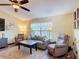 A cozy living room features a large window and comfortable seating arrangement at 3110 Short Leaf Pine Ct, Kissimmee, FL 34746