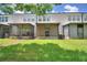 A lovely backyard with a covered patio, green grass, and a view of the building at 3151 Sinclair St # 104, Orlando, FL 32835