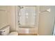 Bright white bathtub and shower combination with tile surround in the bathroom at 3151 Sinclair St # 104, Orlando, FL 32835