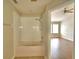 Bright bathroom featuring a tub with a white tiled surround and an open view to the bedroom at 3151 Sinclair St # 104, Orlando, FL 32835