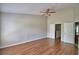This bedroom features wood-look flooring and multiple doorways to other rooms and storage at 3151 Sinclair St # 104, Orlando, FL 32835