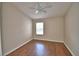 Bright bedroom features hardwood floors, a ceiling fan and a window for natural light at 3151 Sinclair St # 104, Orlando, FL 32835
