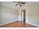 This bedroom features hardwood flooring, ceiling fan and an open doorway at 3151 Sinclair St # 104, Orlando, FL 32835