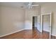 Spacious bedroom features an ensuite bathroom, a closet and hardwood flooring at 3151 Sinclair St # 104, Orlando, FL 32835