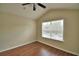Bedroom featuring vaulted ceiling, hardwood flooring and a large window at 3151 Sinclair St # 104, Orlando, FL 32835