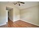 Bedroom offers hardwood flooring, ceiling fan, and a view to the hallway at 3151 Sinclair St # 104, Orlando, FL 32835