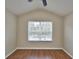 Vaulted ceiling bedroom featuring hardwood flooring and a window view at 3151 Sinclair St # 104, Orlando, FL 32835