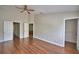 This bedroom features wood-look flooring and multiple doorways leading to bathrooms and walk-in closets at 3151 Sinclair St # 104, Orlando, FL 32835