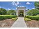 Community clubhouse entrance featuring an inviting walkway and well-manicured landscaping at 3151 Sinclair St # 104, Orlando, FL 32835