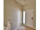 Bright entryway featuring a white front door, light-colored walls, and wood-look flooring at 3151 Sinclair St # 104, Orlando, FL 32835