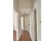 Hallway featuring access to multiple rooms and storage areas, with wood-look flooring throughout at 3151 Sinclair St # 104, Orlando, FL 32835