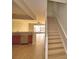 Interior of the home featuring a staircase, a view to the living room, and the kitchen at 3151 Sinclair St # 104, Orlando, FL 32835