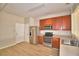 Well-equipped kitchen featuring stainless steel appliances and warm wood cabinetry at 3151 Sinclair St # 104, Orlando, FL 32835