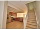 Open-concept kitchen with stainless steel appliances, wood cabinets, and staircase at 3151 Sinclair St # 104, Orlando, FL 32835